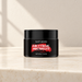 Black EAST MOON jar with red motif on ivory vanity