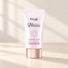 Pale pink sunscreen tube with a rose-gold cap on an ivory surface.