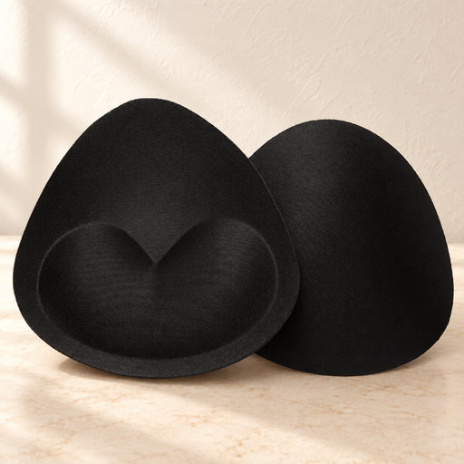Pair of black triangular foam inserts on ivory surface