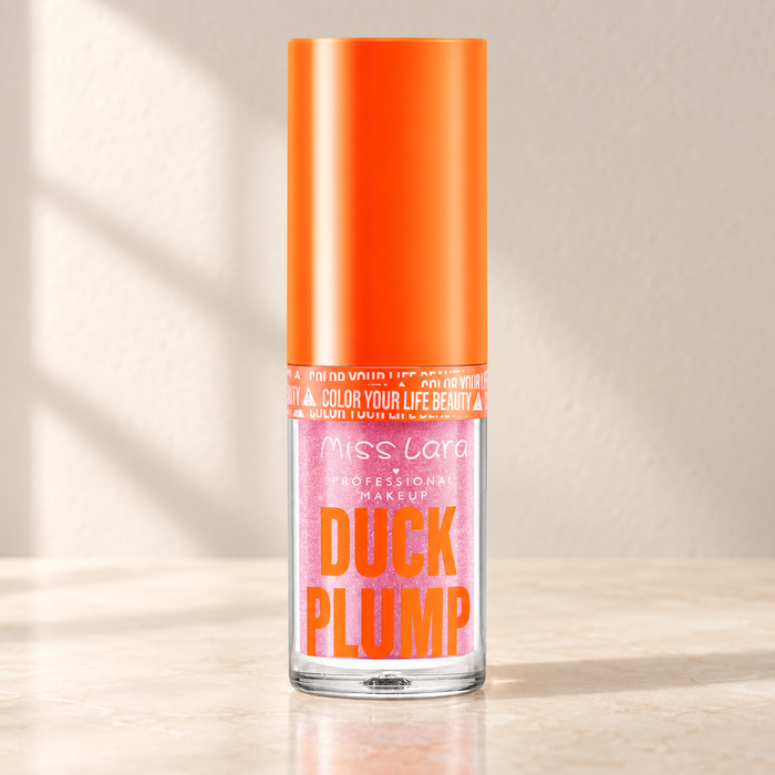 Pink glitter Miss Lara gloss bottle with orange cap on ivory vanity