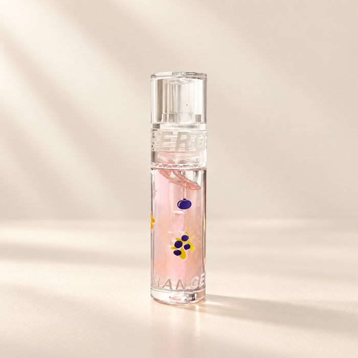 Clear pink lip gloss tube with purple fruit motifs