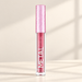 Metallic pink lip colour bottle with a textured pink cap on an ivory surface.