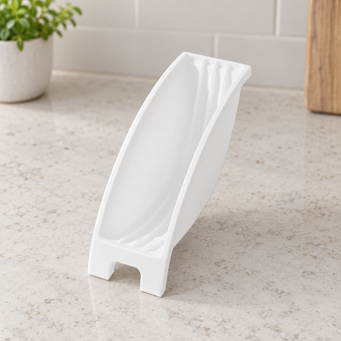 White curved plate organiser on a light kitchen worktop.