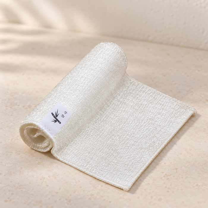 Cream dish cloth partially rolled on ivory kitchen surface
