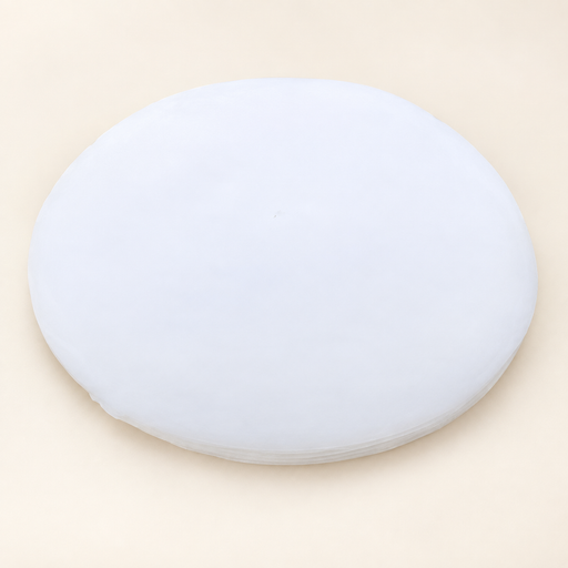 Stack of white circular oil-absorbing sheets on ivory surface