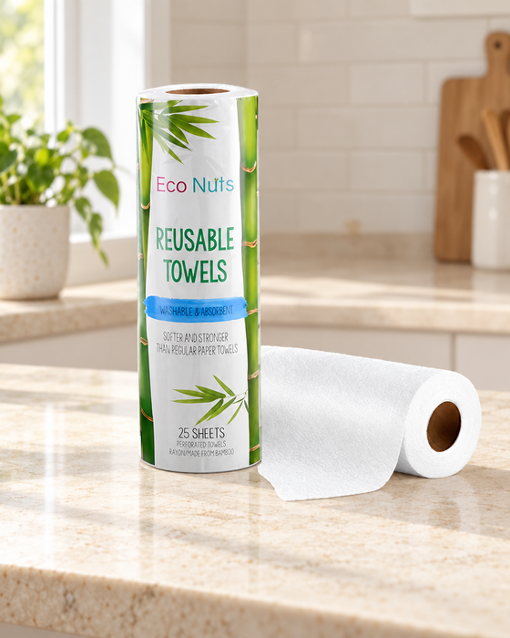 Packaged reusable towel roll beside an unwrapped white roll on an ivory kitchen countertop.