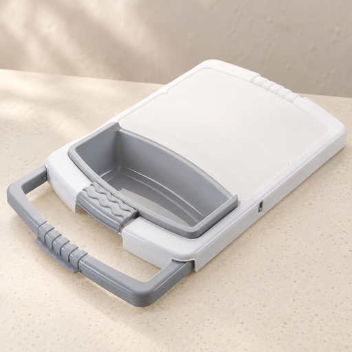 White and grey cutting board with integrated colander on an ivory countertop