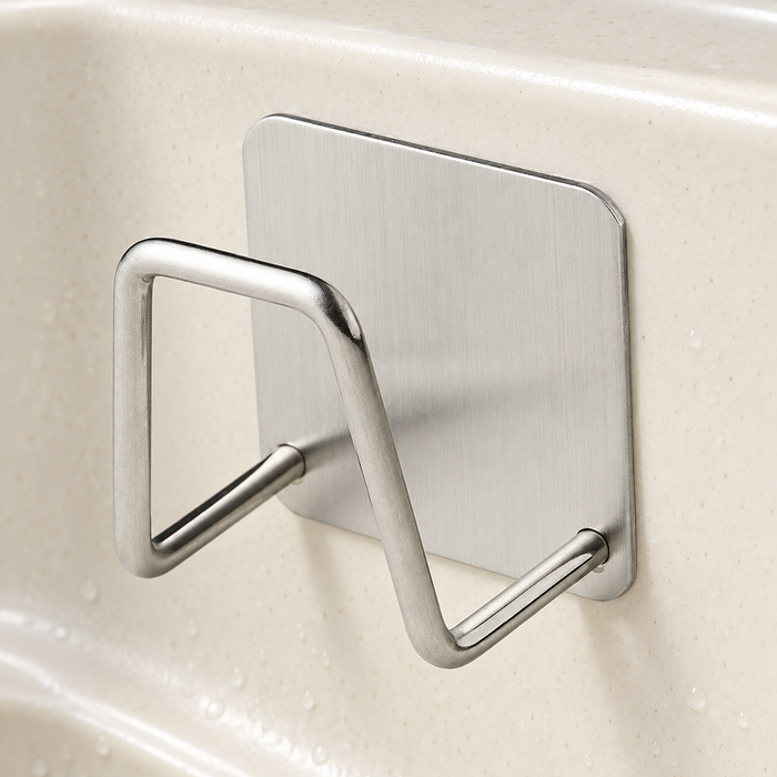 Silver sponge holder mounted inside a kitchen sink.