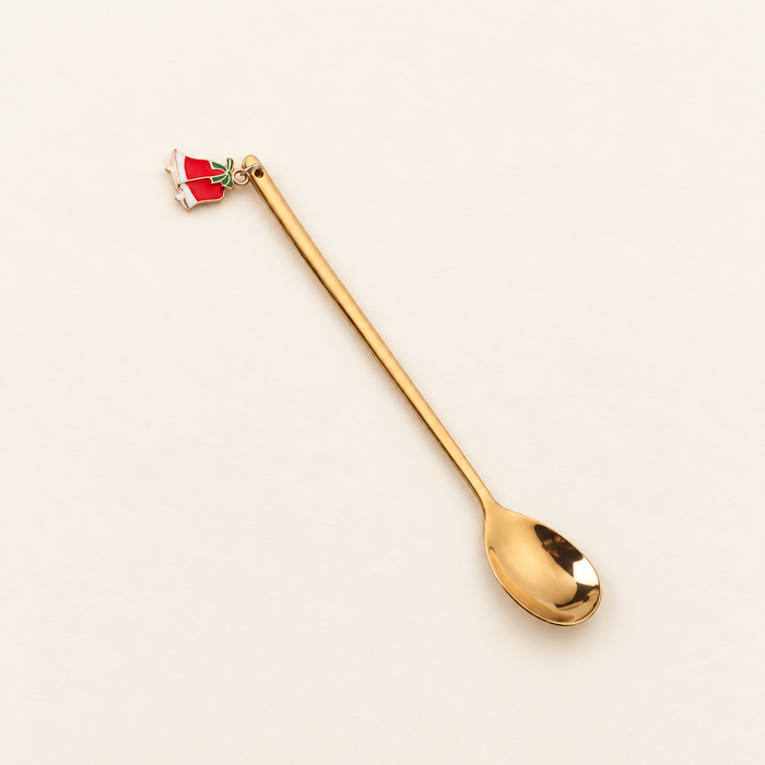 Gold dessert spoon with red bell charm