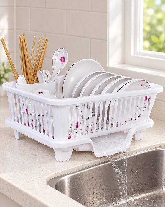 White dish draining rack holding dishes beside a kitchen sink.