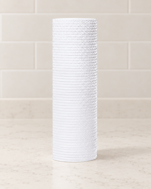 White cleaning towel roll on an ivory kitchen counter.