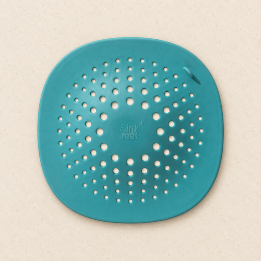Turquoise drain cover with radial holes on ivory surface