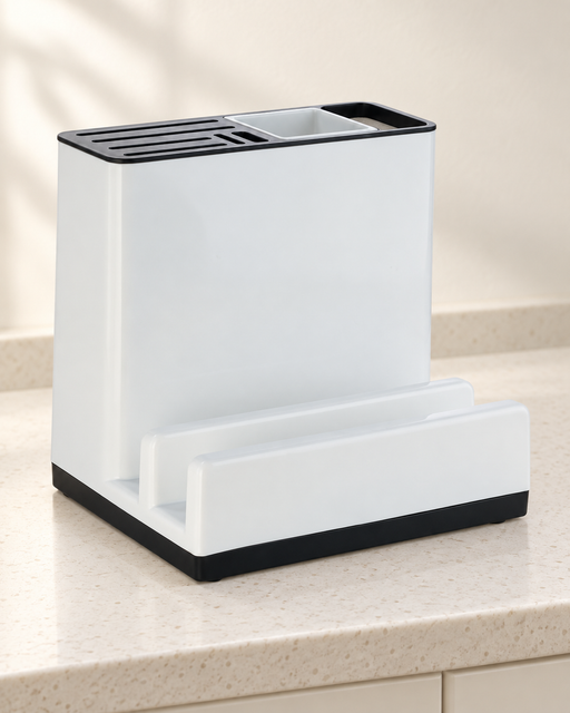 Empty white and black kitchen organizer on an ivory counter.