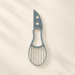 Grey-blue avocado slicing tool with serrated edge and oval grid on an ivory surface.