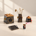 Black and gold incense ceremony set with four tools, tray, jar and bottle on an ivory table.