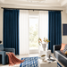 Dark teal curtains in a softly lit sitting room