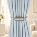 Silver-grey magnetic tieback around a pale blue curtain