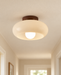 Cream rounded ceiling light with a dark brown mount.