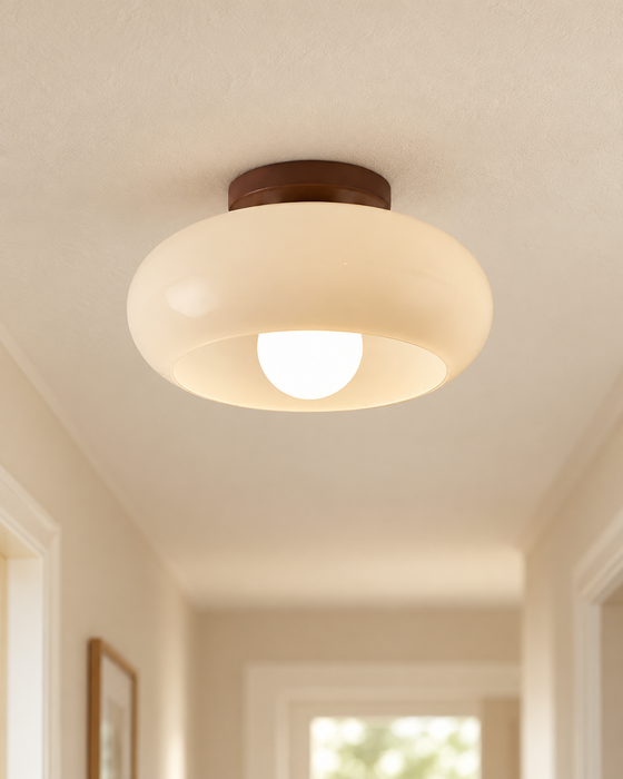 Cream rounded ceiling light with a dark brown mount.