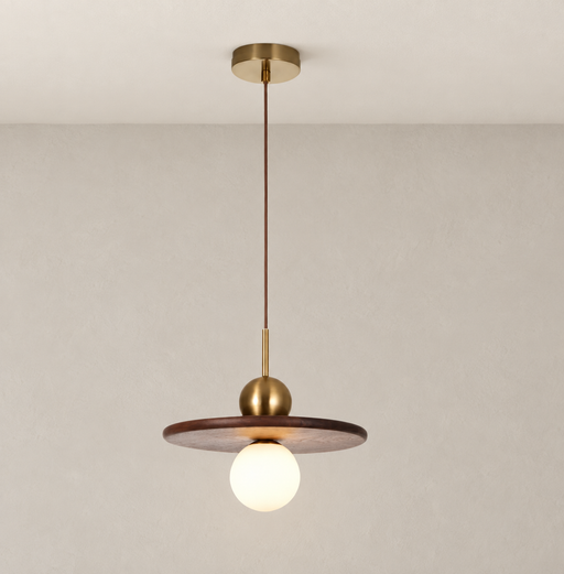 Walnut disc pendant with gold fittings and a glowing globe