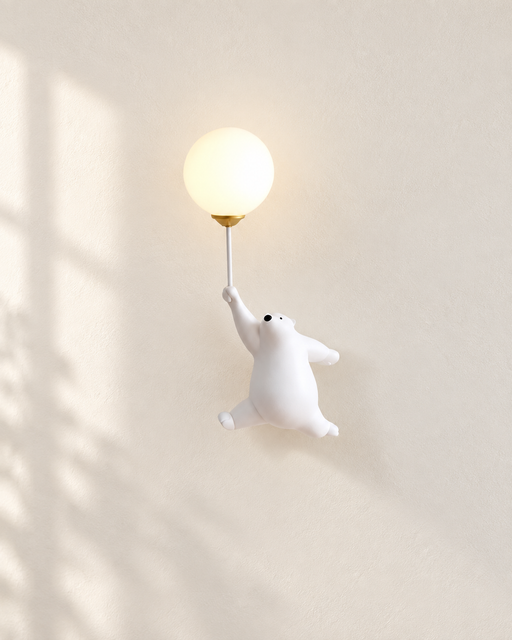 White bear-shaped wall lamp holding a glowing globe against ivory plaster.