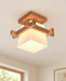 Wood-tone square ceiling light with a frosted shade.