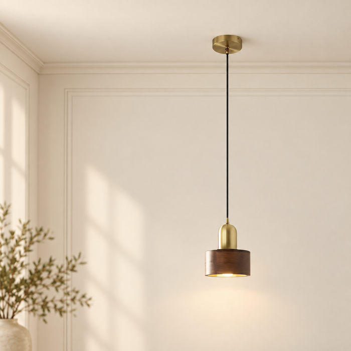 Walnut and brass pendant lamp with black cord in an ivory interior.