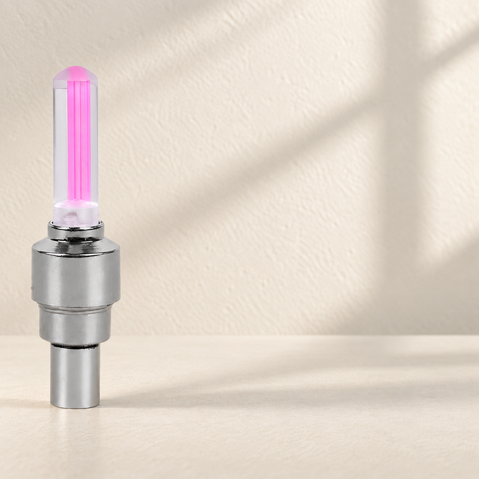 Silver bicycle valve light with a translucent pink illuminated top