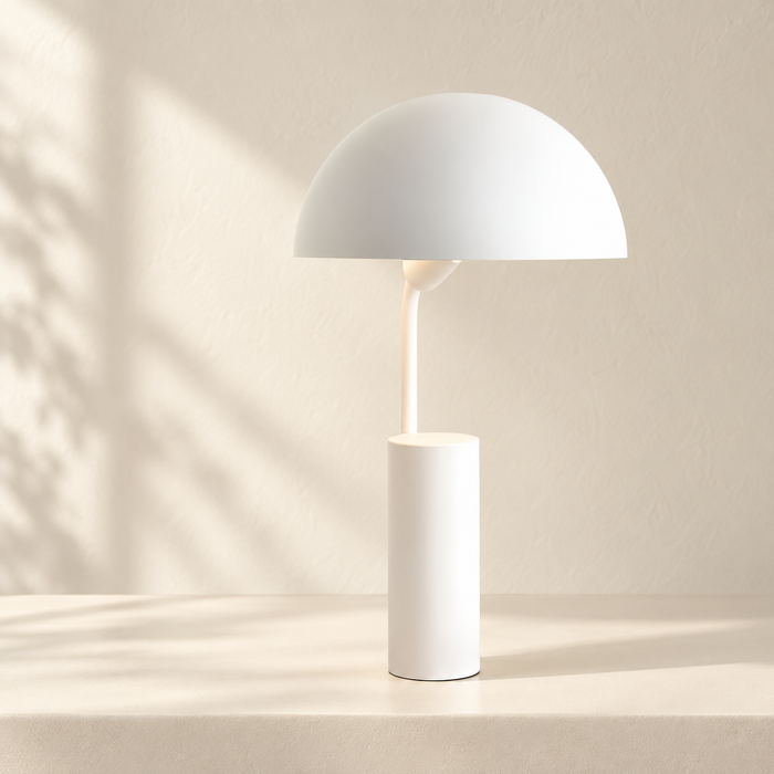 White dome desk lamp with a cylindrical base on an ivory console