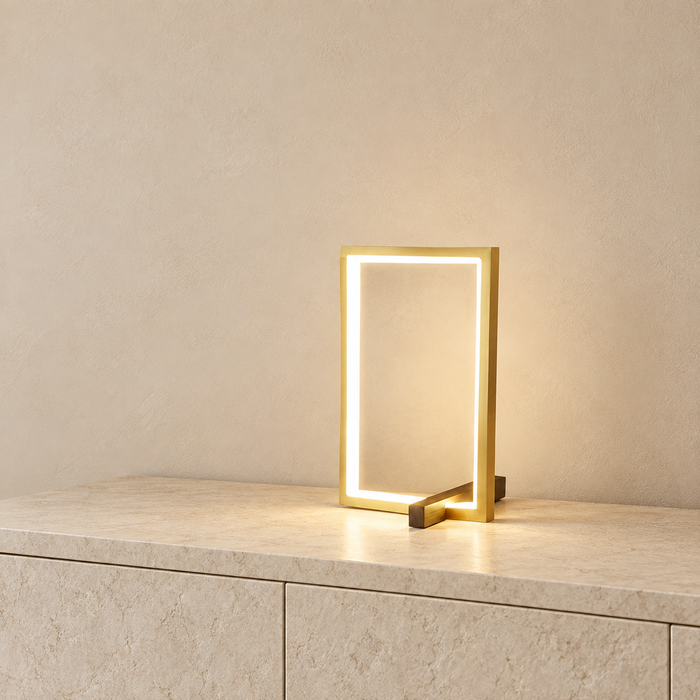 Gold open-frame table lamp on an ivory sideboard