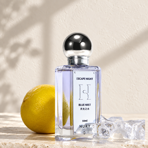 Blue Mist fragrance bottle with a silver spherical cap beside citrus and ice