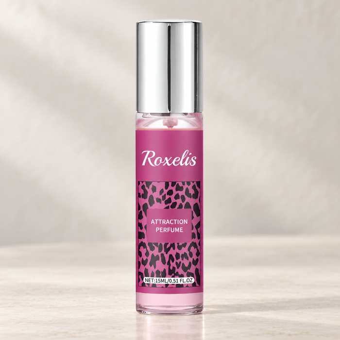 Pink fragrance bottle with silver cap on ivory vanity
