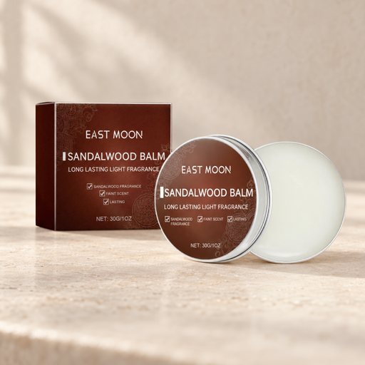 Sandalwood solid balm with its original brown packaging on a warm stone vanity.
