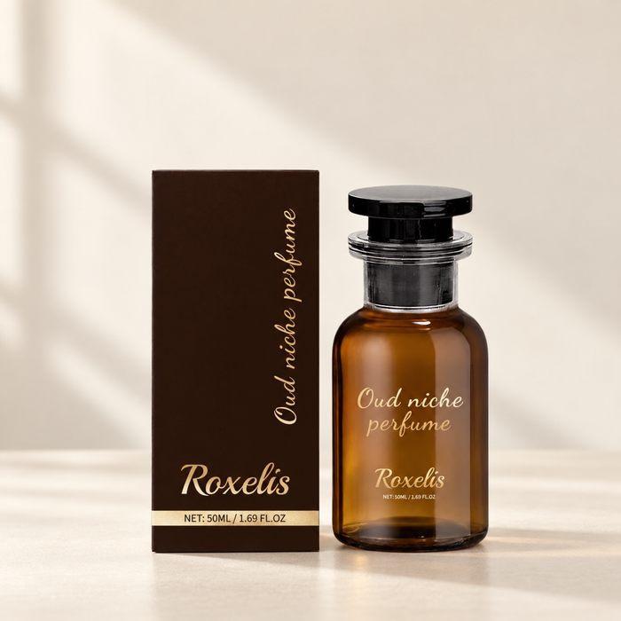 Amber perfume bottle and brown box on ivory tabletop