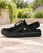 Black closed-toe hiking sandal with mesh panels, a cord closure and an adjustable heel strap.