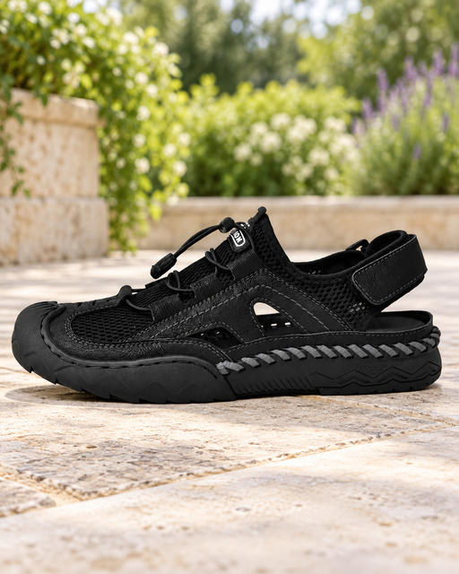 Black closed-toe hiking sandal with mesh panels, a cord closure and an adjustable heel strap.