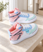 Pastel high-top sneakers with pink straps, light blue and mint panels, and white soles on a stone bench.