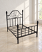 Bare black metal pet bed frame with a decorative scroll headboard in an ivory room.