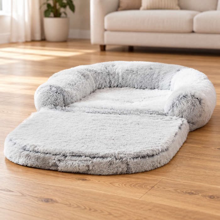 Light grey plush pet sofa bed on a wooden living-room floor.