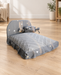Grey pet bed with geometric white lines, triangle motifs and a tied bolster in a living room.