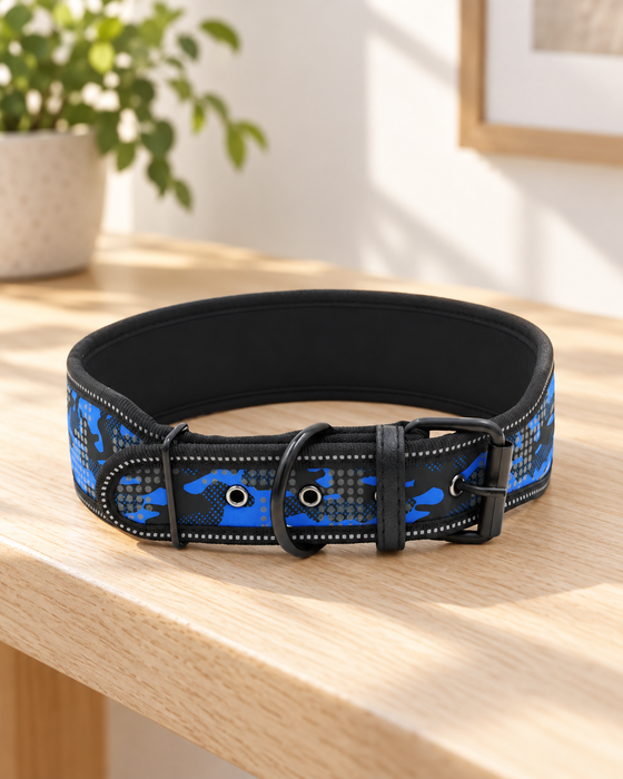 Blue and black camouflage dog collar with black buckle and ring on a light wooden bench.