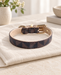 Brown and charcoal patterned pet collar with beige lining and gold-tone hardware on ivory linen.