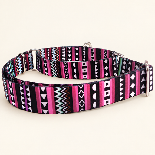 Pink and black patterned dog collar with metal fittings on an ivory surface