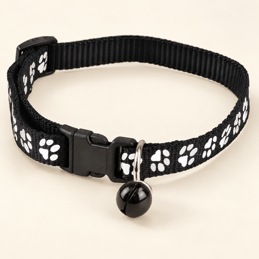 Black paw-print pet collar with bell on ivory background