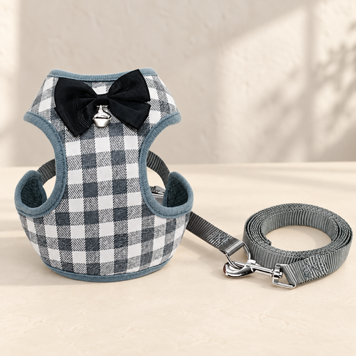 Grey and white checked pet harness with black bow, silver bell and rolled grey leash.