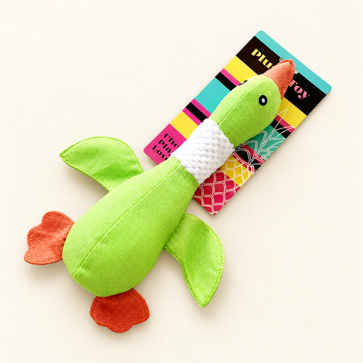 Green plush duck dog toy with original colourful product card on ivory surface