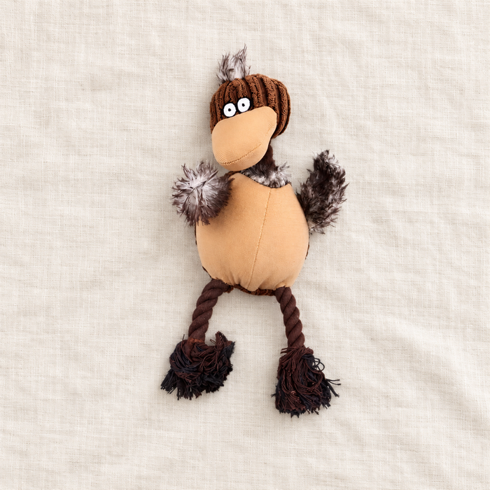 Brown plush bird dog toy with rope legs on ivory linen