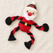 Santa-shaped rope dog toy with red and black limbs on ivory linen