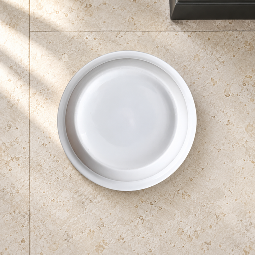 White ceramic pet bowl on an ivory stone floor.