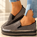 Black rhinestone slip-on shoes with stitched soles worn with cropped jeans